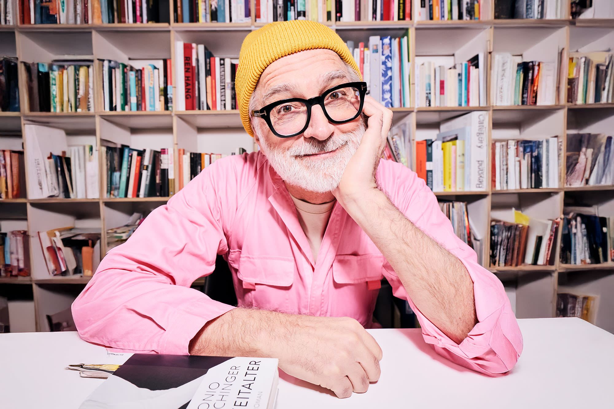 Muž s ružovou košeľou pred policou s knihami - klasické formy investícií do medzigeneračného bohatstva Muž s ružovou košeľou pred policou s knihami - klasické formy investícií do medzigeneračného bohatstva